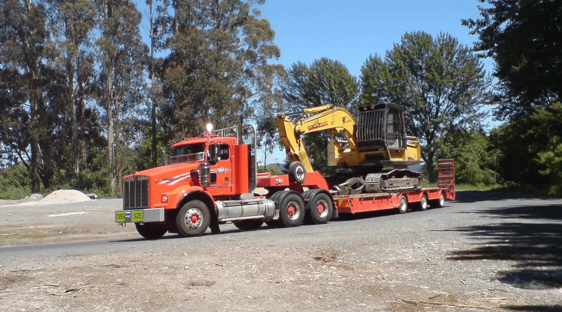 Excavator On A Truck Bed min
