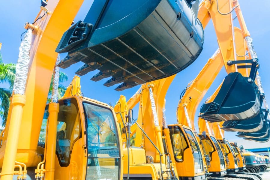 close up view of a row of yellow excavators