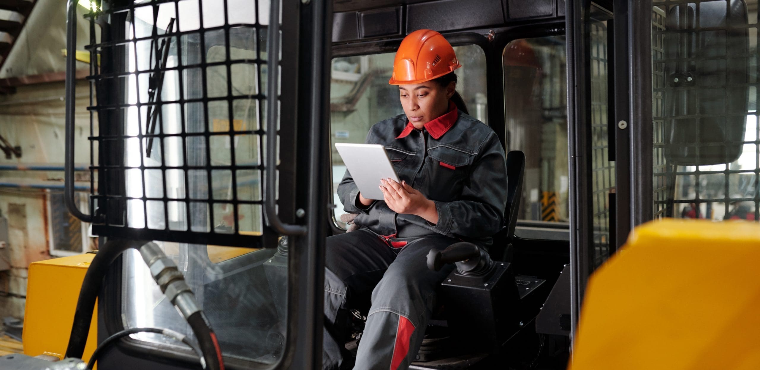Female construction worker solving supply chain issues with digital tablet